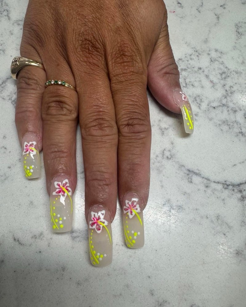 Clear coffin nails with hand-painted white hibiscus flowers and neon yellow accents